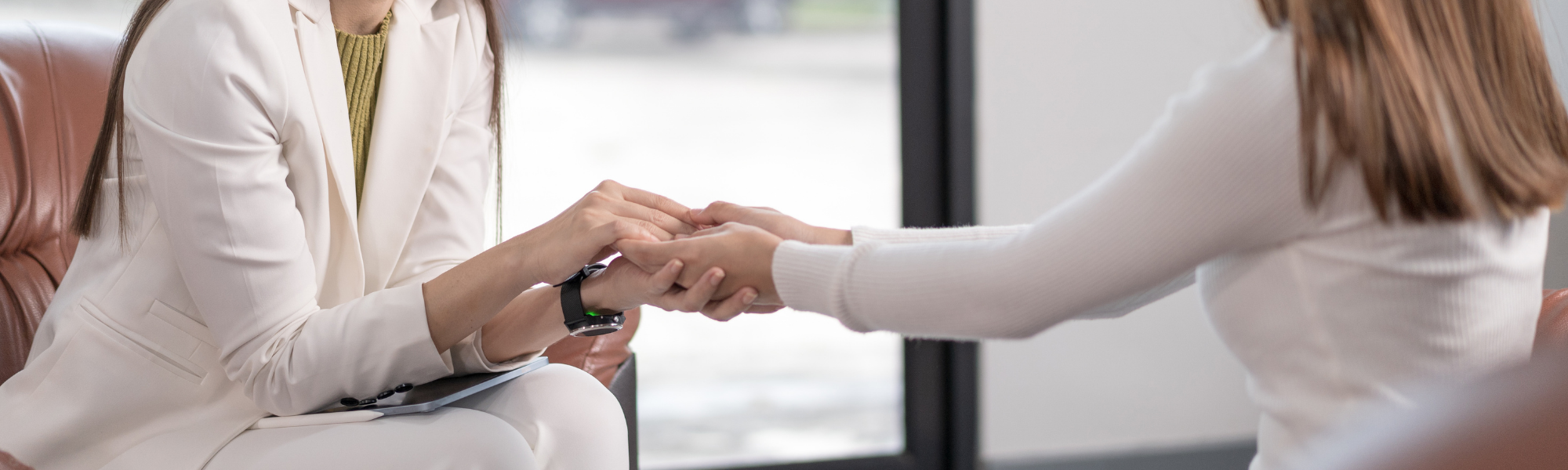 counselor holding a patient's hand 